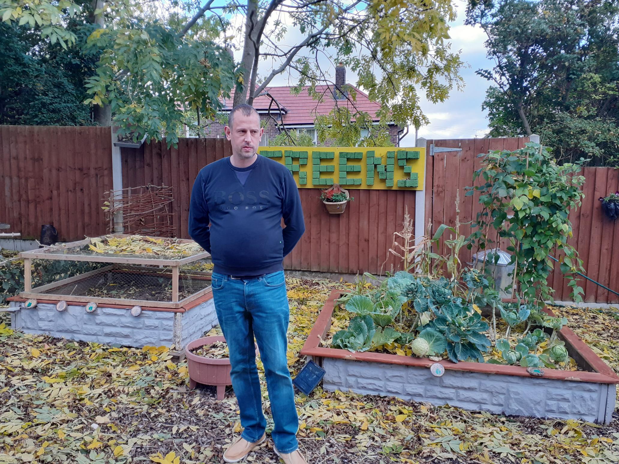 Greg, a resident at The Greens, in their garden