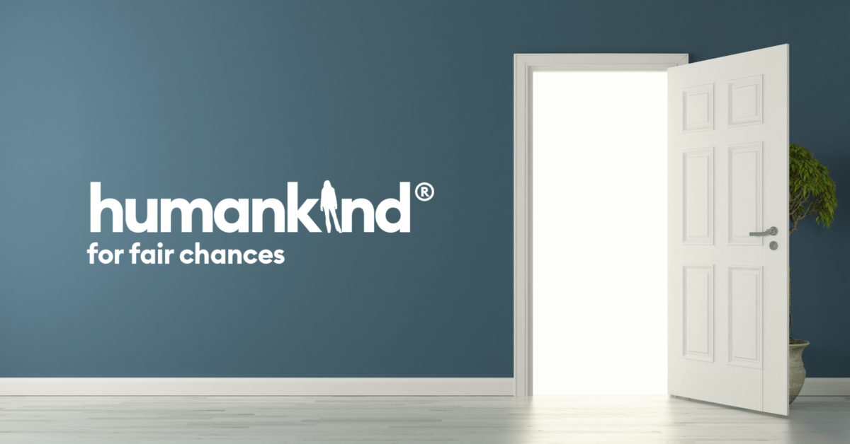 An image showing an opened door. The humankind logo appears in white to the left of the door