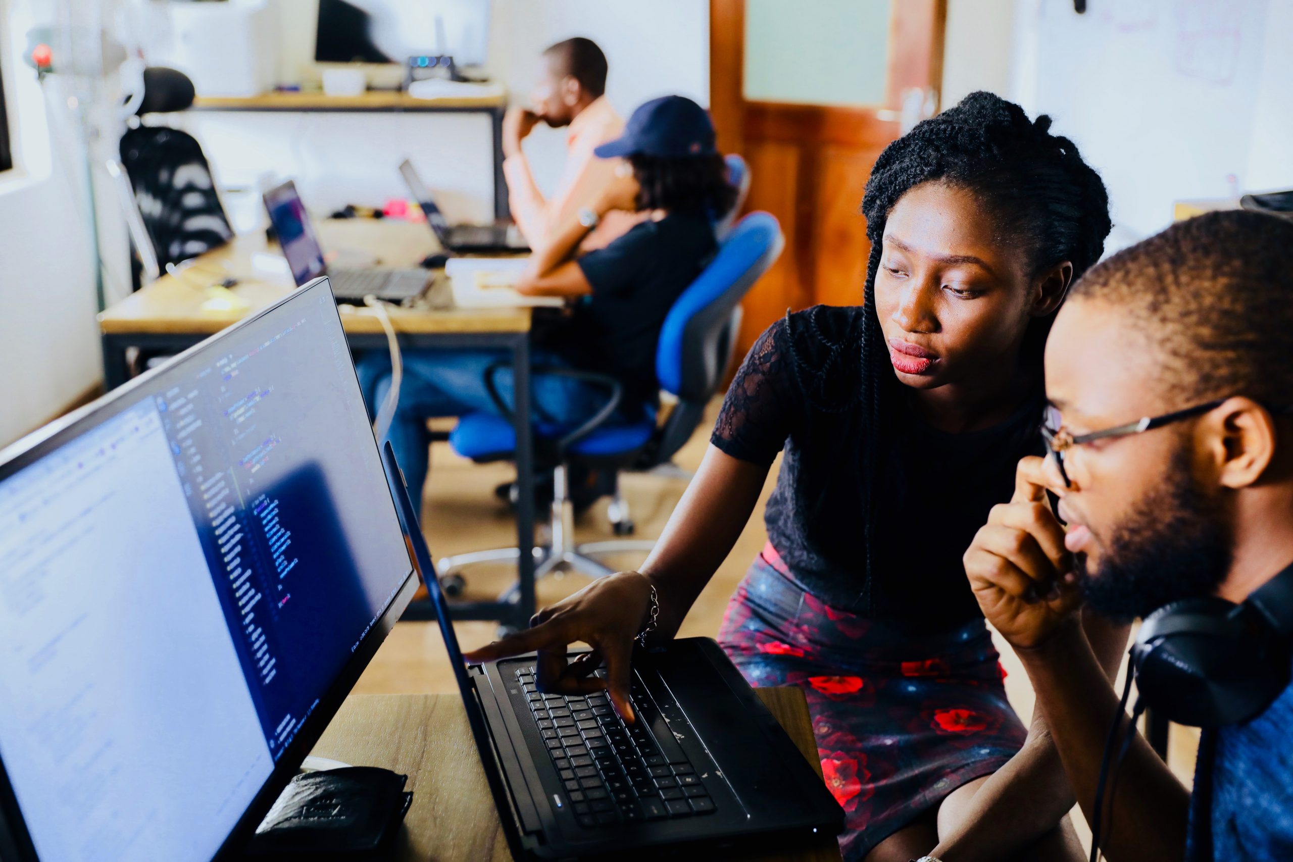 People working together at a computer in an office