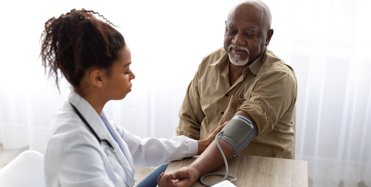 Female doctor takes a blood pressure reading from someone's arm