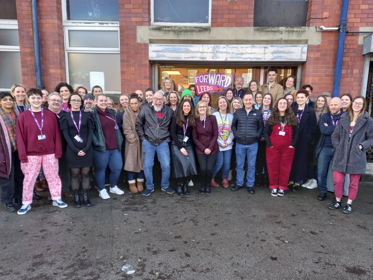 Staff at Forward Leeds pose for a photo outside of their Armley Park Court office