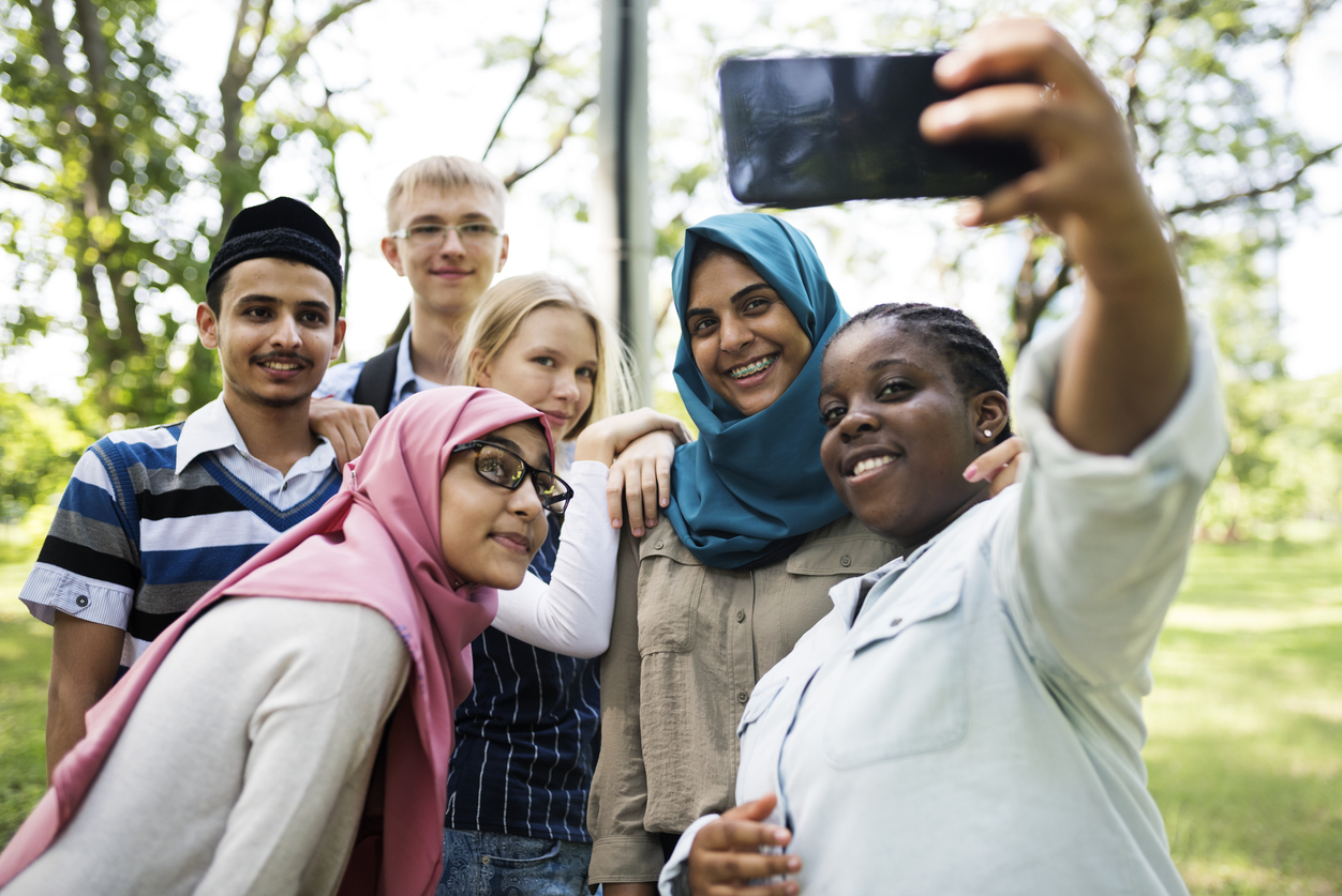 Group of students using mobile phone to take a selfie