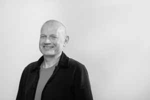 Black and white photo of Humankind CEO, Paul Townsley smiling.