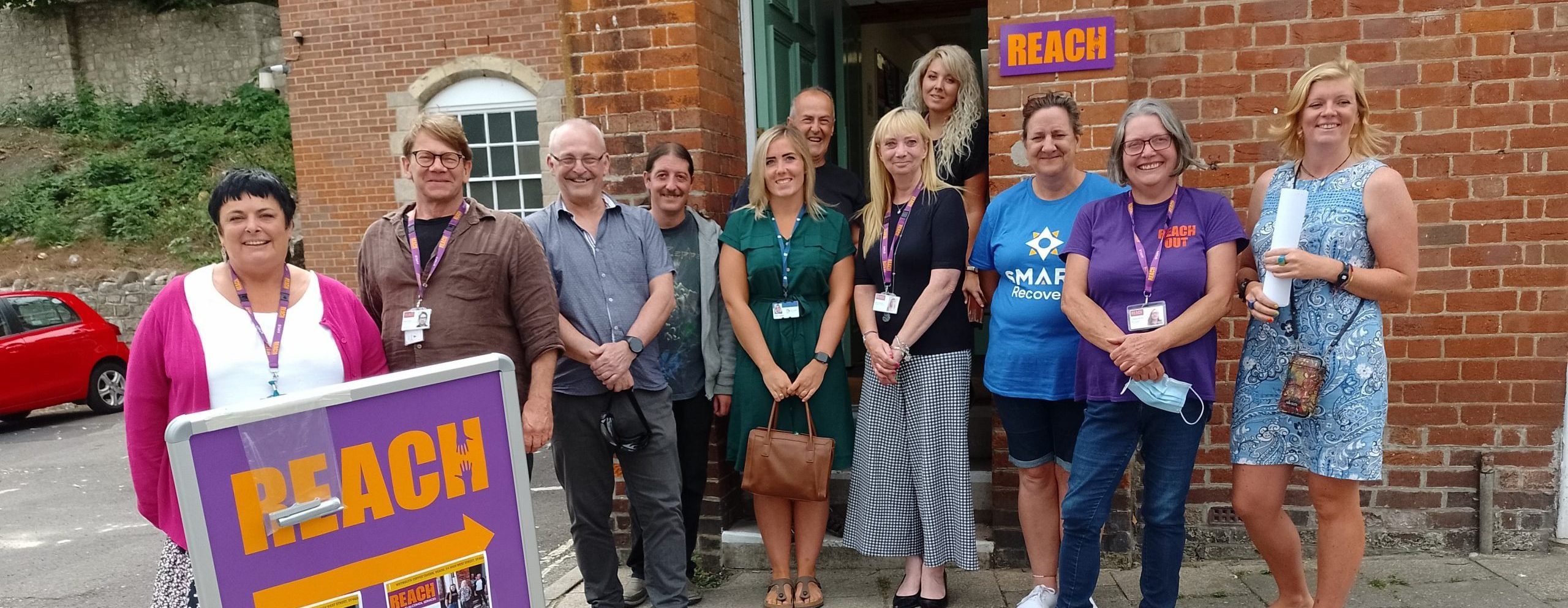 REACH Weymouth team stood outside their hub.