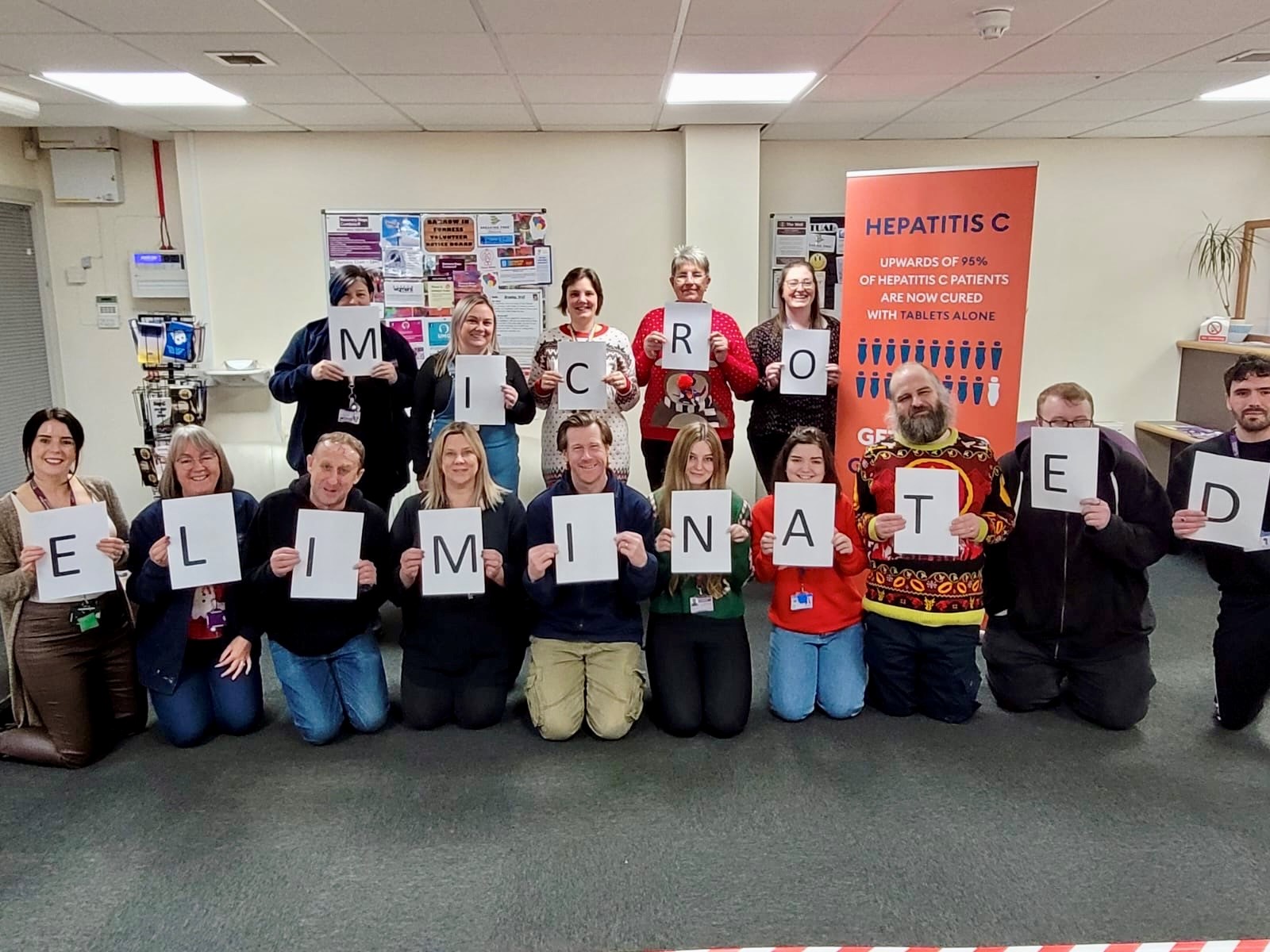 The Recovery Steps team in South Cumbria, each holding up a piece of paper that collectively spell 'Micro eliminated"